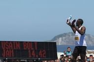 Usain Bolt takes off his running shoes in Rio de Janeiro, Brazil, on March 31, 2013